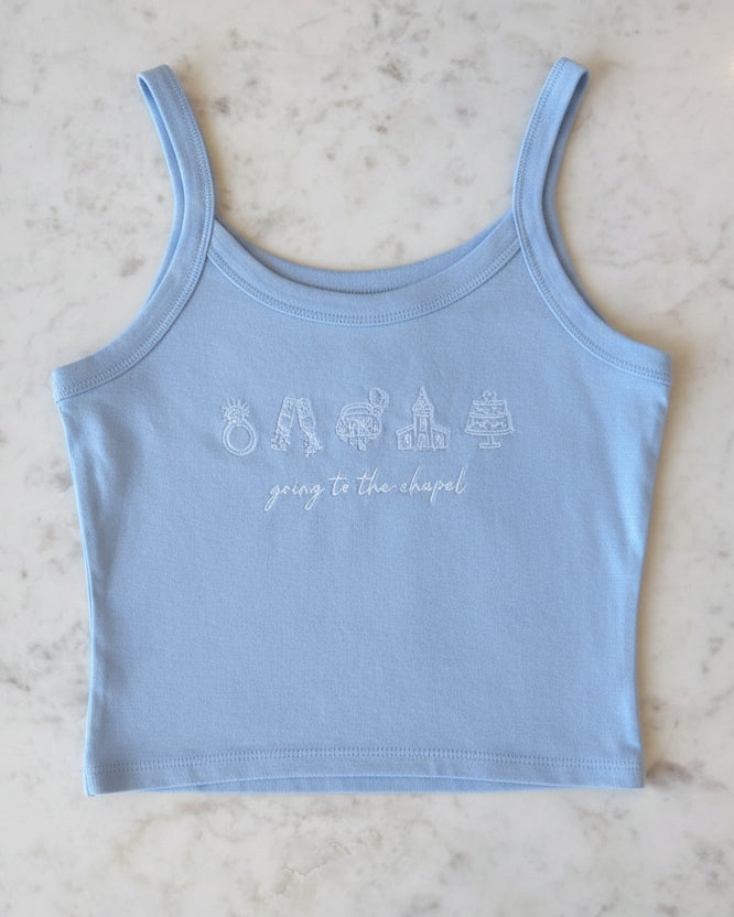Light blue tank top with text on a marble surface